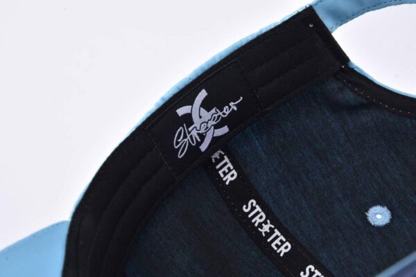 the inner label on the dark blue baseball cap KN2103126