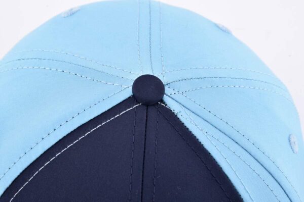 the top crown of the dark blue baseball cap KN2103126