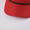 the curved brim of the red unisex baseball cap KN2012112