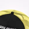 Aung Crown unisex black and yellow trucker hat with a black top button KN2012091