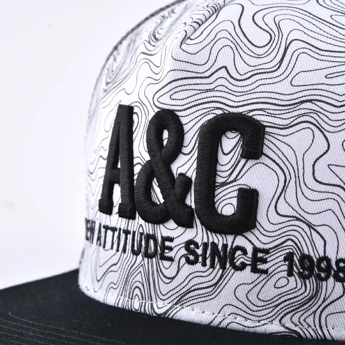 Aung Crown unisex white and black trucker hat with a 3D emboidery and flat embroidery logo on the front KN2103033 Aung Crown unisex white and black trucker hat with a 3D emboidery and flat embroidery logo on the front KN2103033