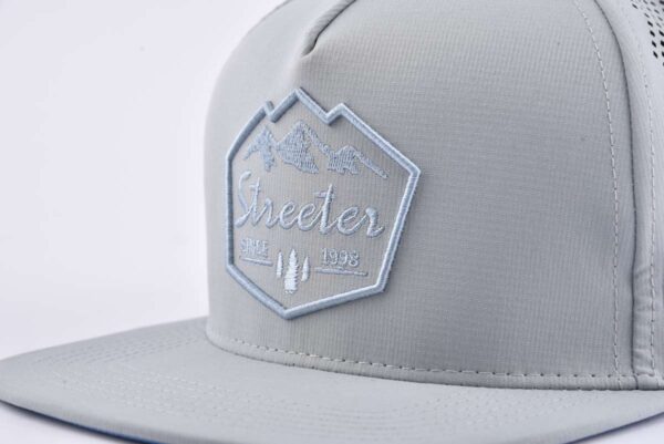 Streeter sports trendy trucker hat with a 3D and flat embroidery logo on the front KN2103125