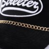 Streeter unisex mesh trucker hat with a golden decorative chain between the crown and the brim KN2102051